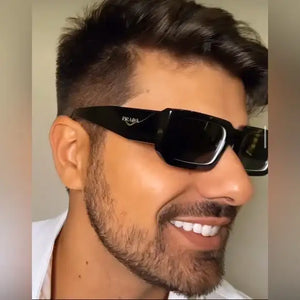 Black prada sunglasses with a rectangular frame and sleek, modern design.