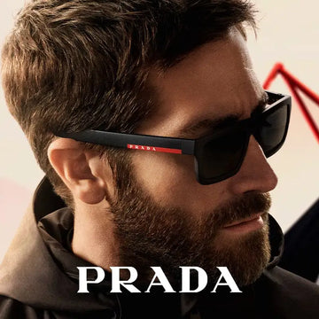 Black prada sunglasses with a red logo stripe on the temple.