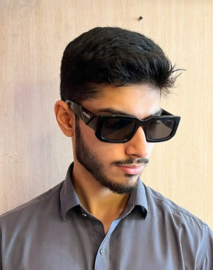 Black rectangular prada sunglasses with dark lenses and a sleek, modern design.